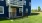 a blue building with a yard