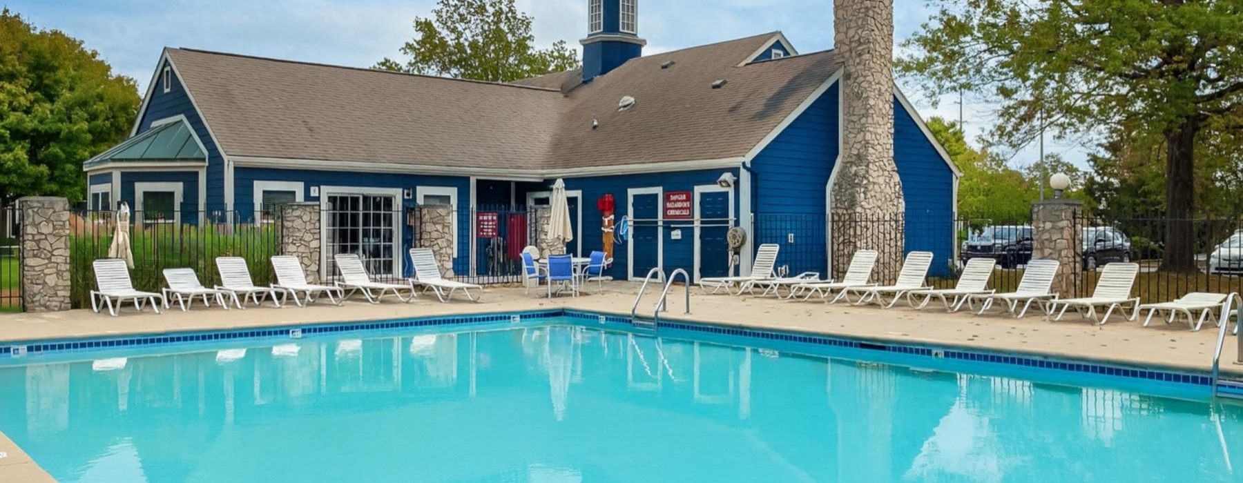 a swimming pool with chairs around it