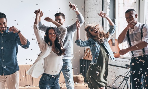 People dancing around in a room 