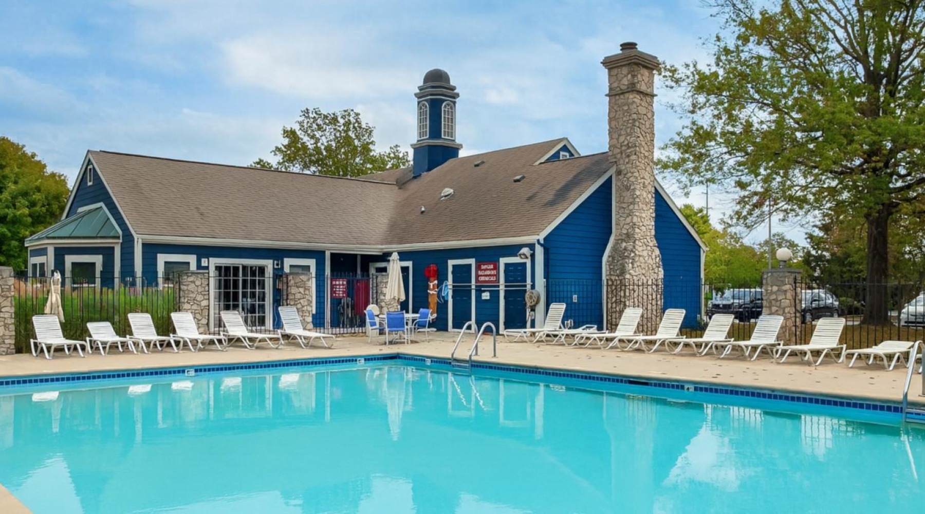 a swimming pool with chairs around it