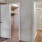 a room with white doors leading into a closet and hallway